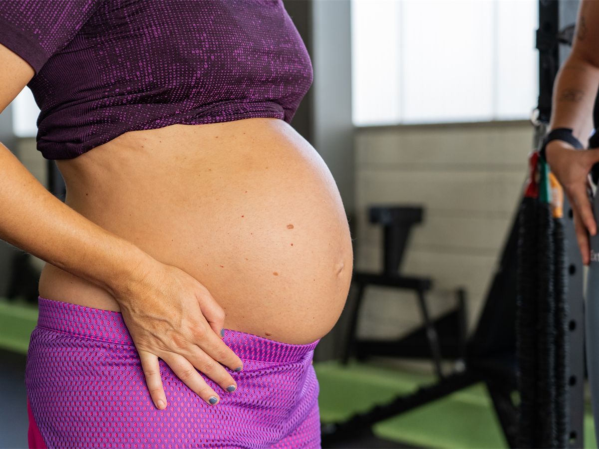 Pregnant woman with her hand on her belly